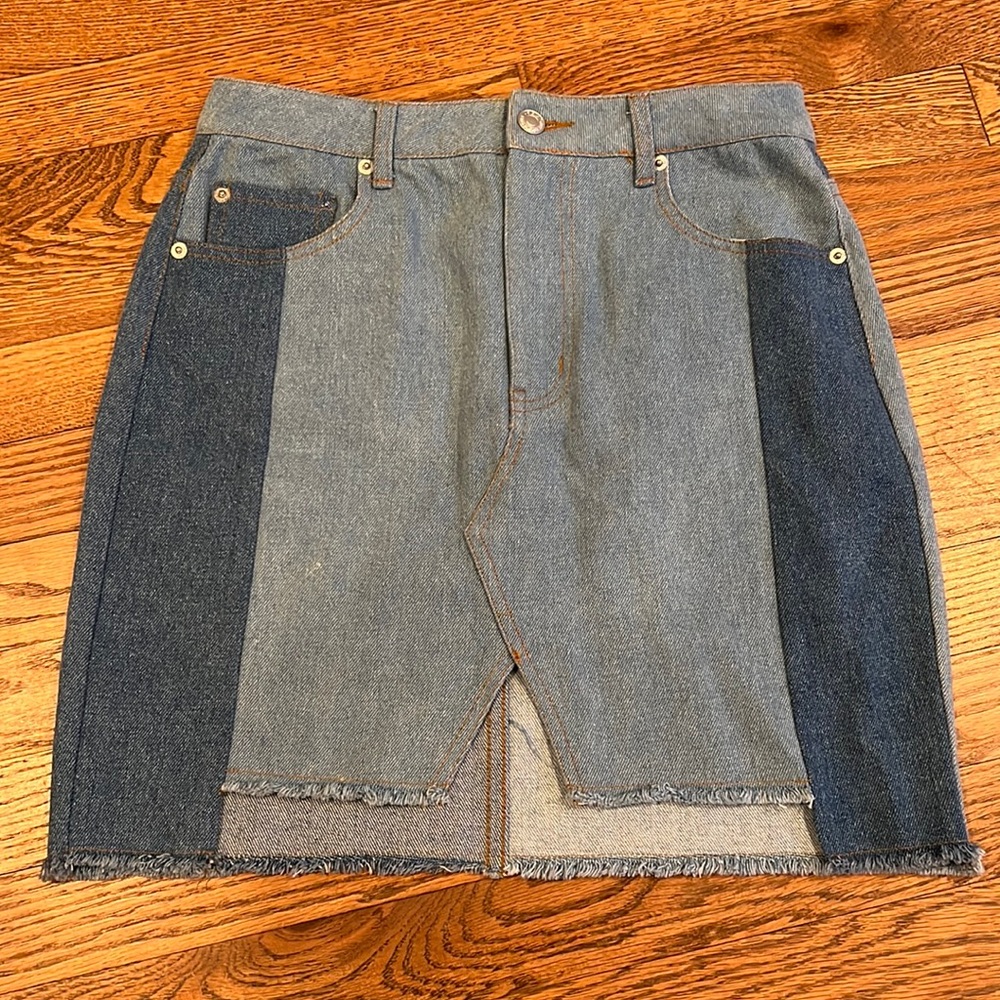 Small patched denim jean skirt. Barely noticeable stain in 5th and 6th picture.